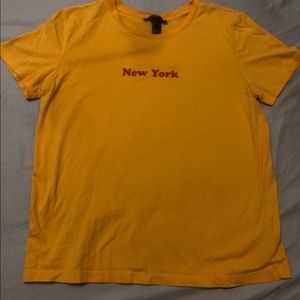 a mustard yellow tee shirt